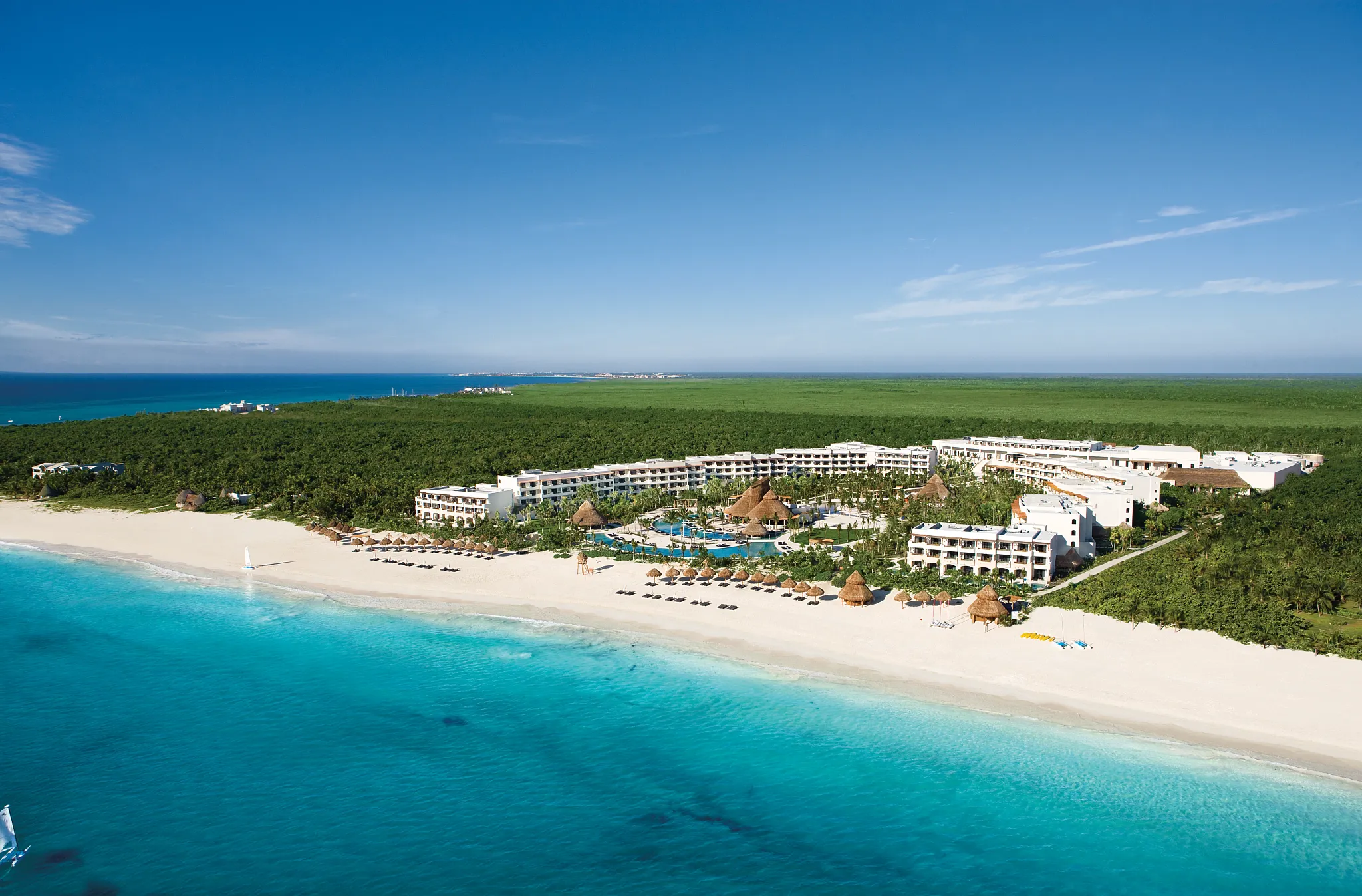 Aerial view of Secrets Maroma Beach Riviera Cancun set along white-sand Maroma Beach and turquoise Caribbean waters.