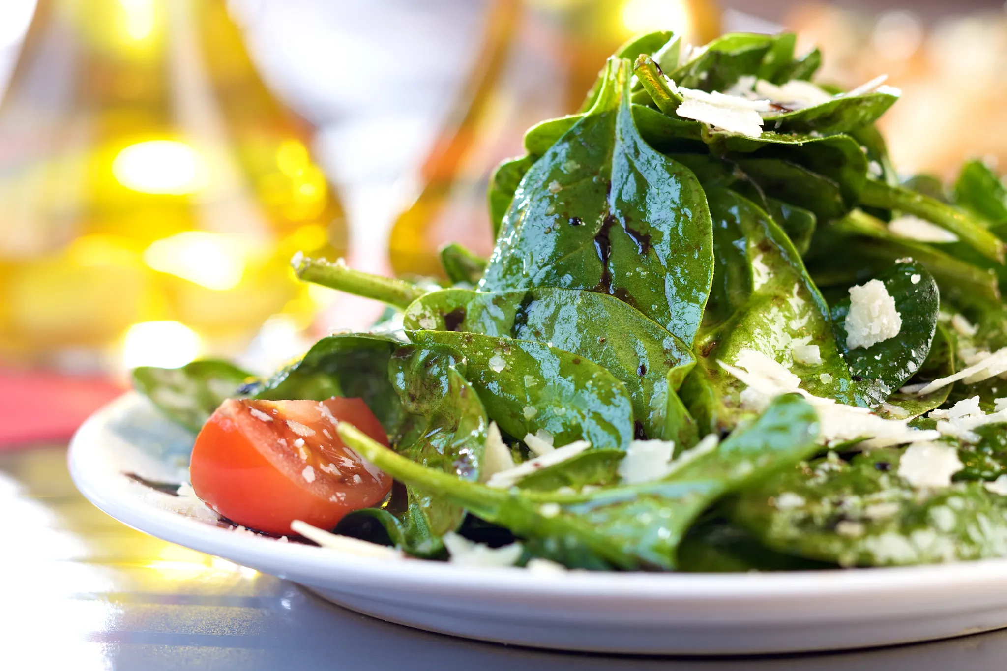 Fresh spinach salad with cherry tomatoes and shaved Parmesan served at Barefoot Grill at Secrets Maroma Beach Riviera Cancun.