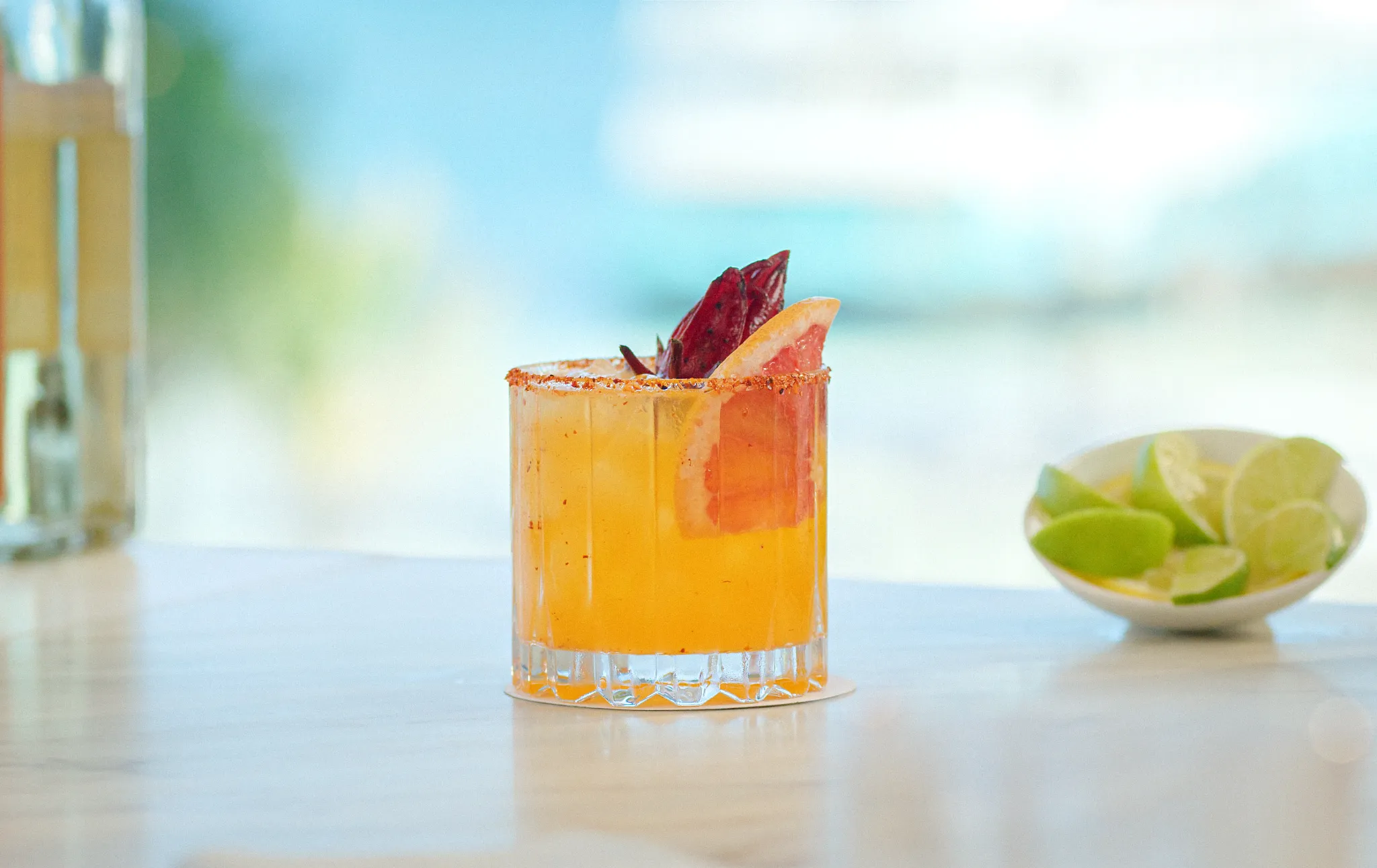 Signature tequila cocktail with citrus garnish served at Barracuda Pool & Beach Bar at Secrets Maroma Beach Riviera Cancun.
