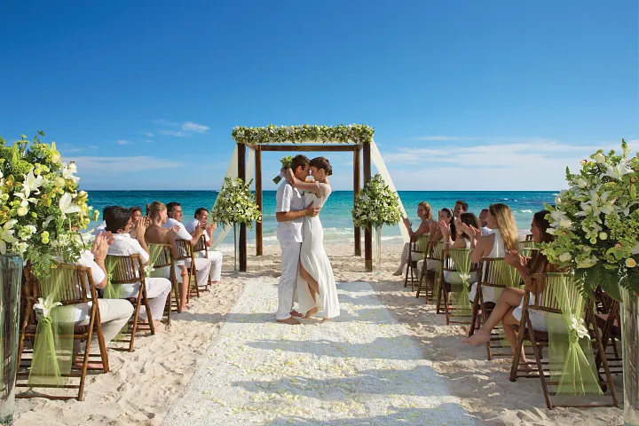 Beach wedding ceremony with floral arch at Secrets Maroma Beach Riviera Cancun