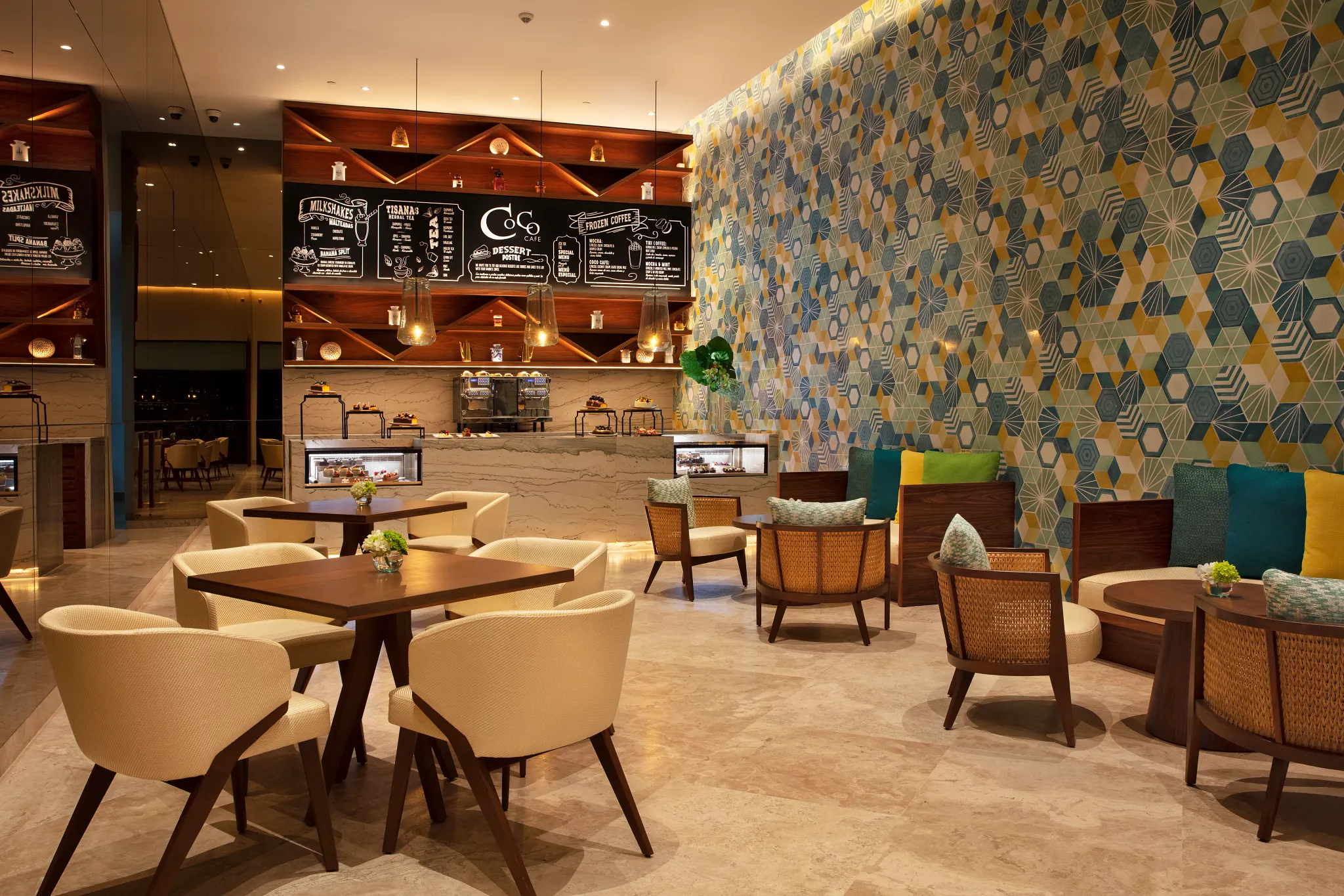 Modern interior of Coco Café at Secrets Maroma Beach Riviera Cancun featuring specialty coffee bar, desserts, and cozy lounge seating.