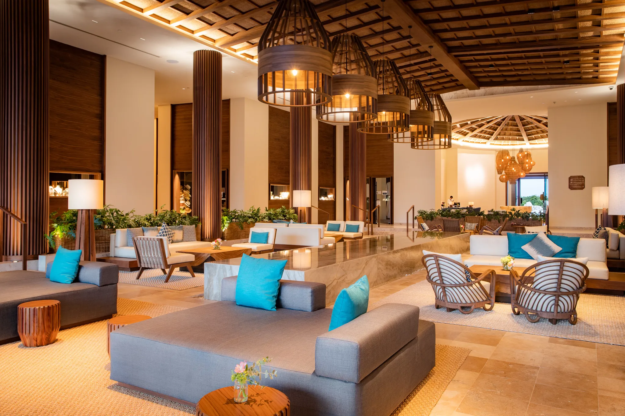 Spacious open-air lobby with high ceilings and elegant seating at Secrets Maroma Beach Riviera Cancun.