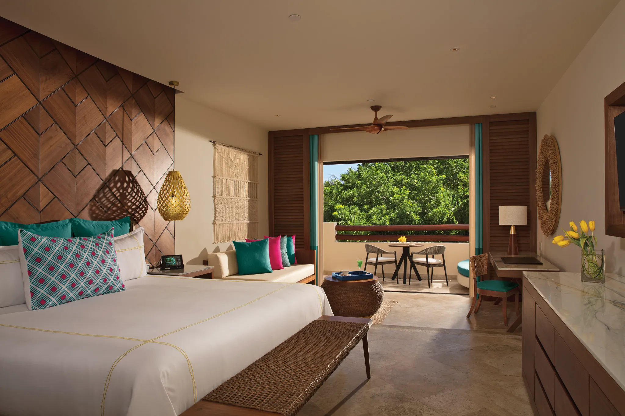Junior Suite Tropical View with king bed, sitting area, and garden-view balcony at Secrets Maroma Beach Riviera Cancun.