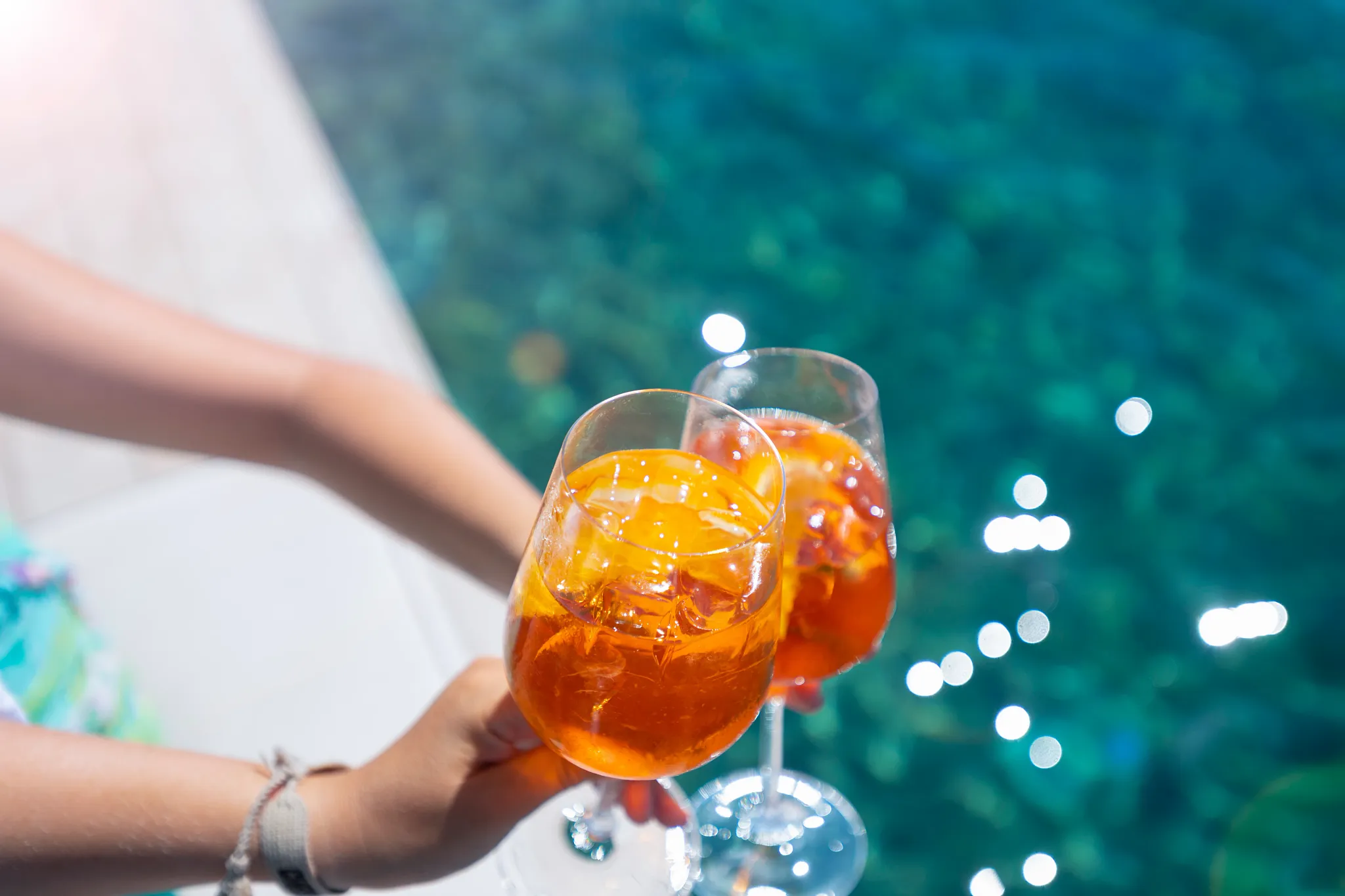 Guests enjoying refreshing cocktails at Manatees Swim-Up Bar pool at Secrets Maroma Beach Riviera Cancun.