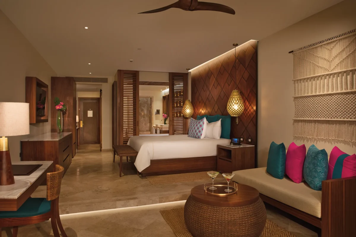 Preferred Club Junior Suite Ocean View with king-size bed and sitting area at Secrets Maroma Beach Riviera Cancun.