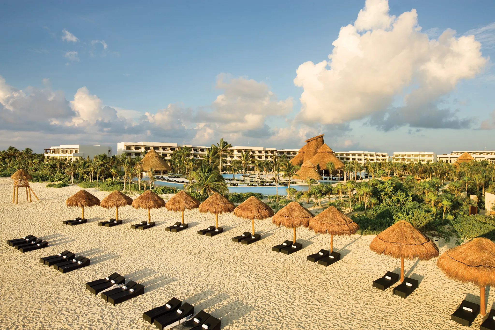 Aerial view of Secrets Maroma Beach Riviera Cancun overlooking white-sand beach and infinity pools.