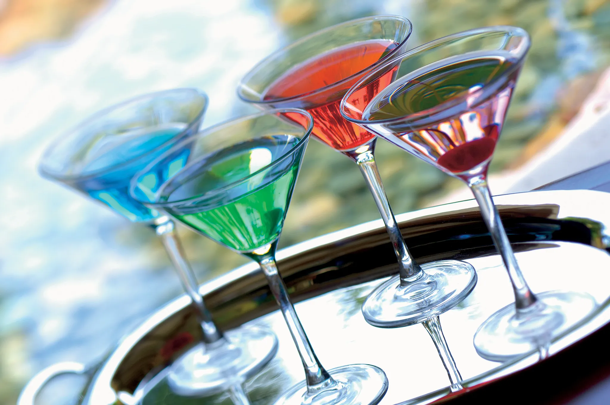 Colorful tropical martinis served at Sugar Reef Poolside Bar at Secrets Maroma Beach Riviera Cancun.